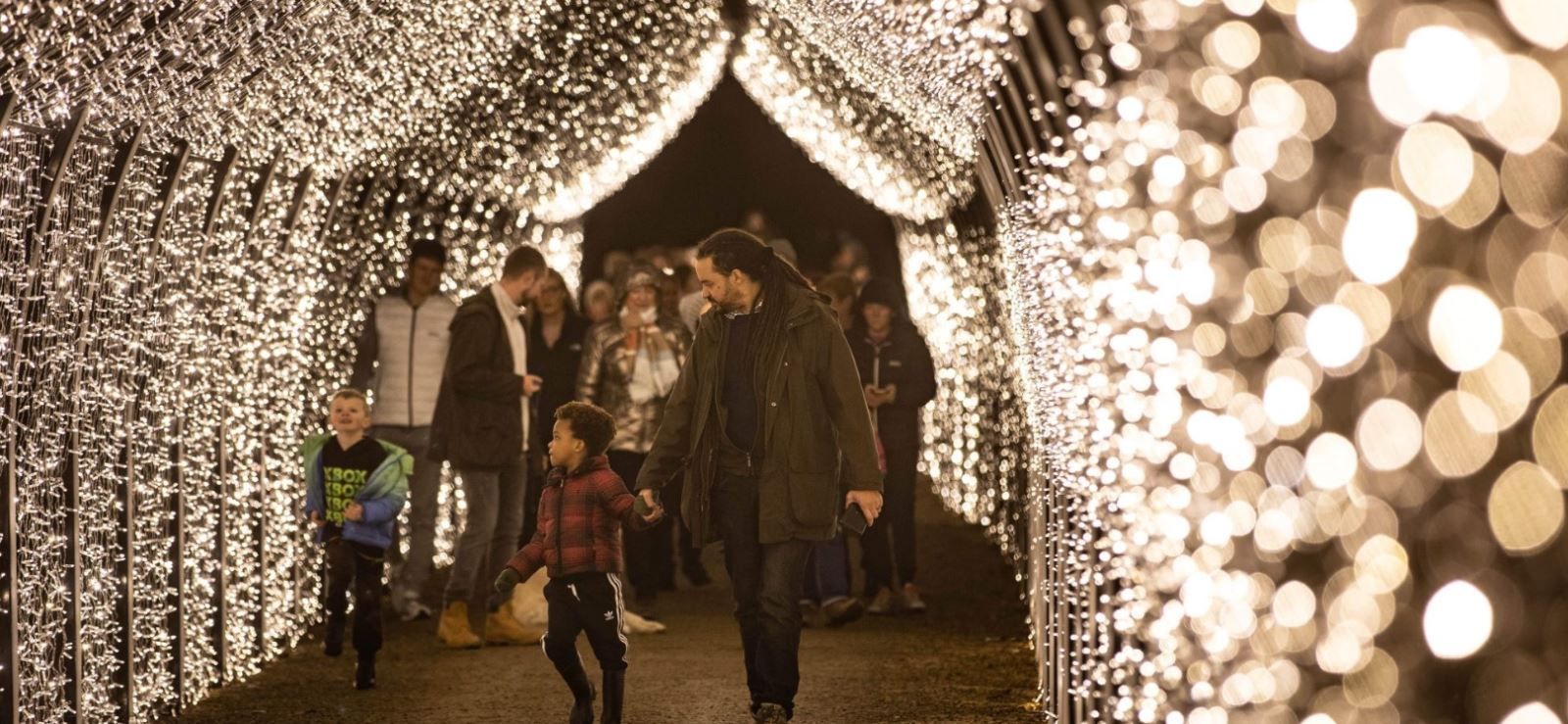 People walking through a light tunnel at Aglow