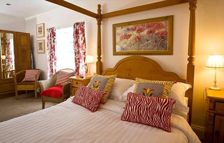 The Penny Red bedroom at The Old Post Office Durham with four poster bed